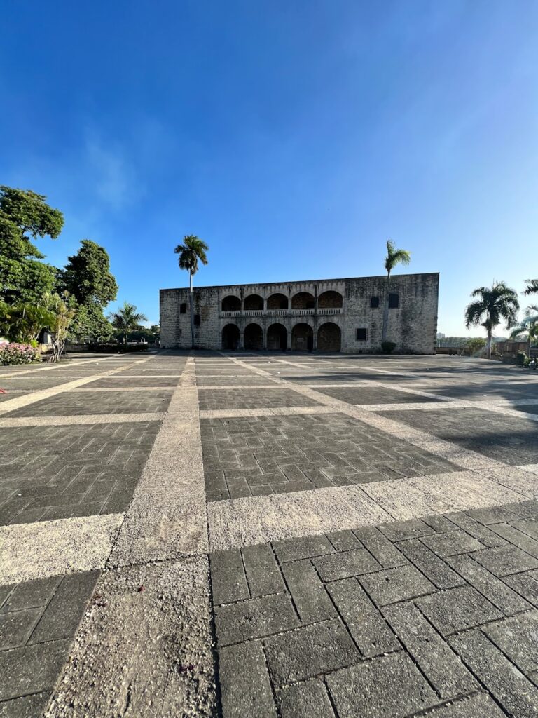 a large building with a palm tree in the background